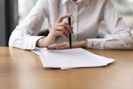 front-view-business-woman-clicking-pen.jpg